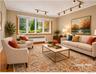 The sunken living room features a bow window and original oak floors under the carpeting.