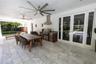Spacious covered outdoor living area with built-in BBQ Kitchen, dining area, and plenty of space for entertaining.