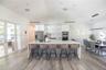 Oversized Kitchen island with generous counter space and ample seating, perfect for entertainment.