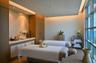 Full-height windows, recessed lighting, built-in cabinetry, an integrated vanity with vessel sink, and an accent wall with reflective tile