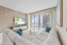 Expansive living area with neutral wall tones and recessed lighting
