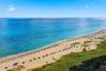 Expansive beachfront with clear blue water and sandy shores