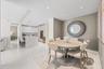 Open-concept living space featuring a dining area, recessed lighting, and white tile flooring