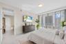Floor-to-ceiling glass doors opening to a private balcony