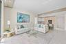 Recessed lighting, wood-finish flooring, a kitchen island with built-in appliances, and a wall of glass doors