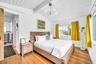 Vaulted wood-plank ceiling, wood-finish flooring, large window, and modern chandelier