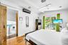 Hardwood flooring, sliding barn door, wall-mounted air conditioning unit, recessed lighting, and glass sliding doors with exterior access