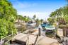Waterfront canal access with multiple docks and lush tropical landscaping