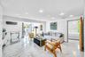 Recessed lighting, large format stone-finish tile flooring, wall-mounted air conditioning unit, glass sliding doors, and a wood door frame