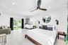 Recessed lighting, ceiling fan, white cabinetry with integrated sink, glass French doors, and a manicured lawn
