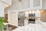 Stainless appliances complement the kitchen's clean and updated design.