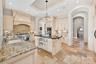 The kitchen is a culinary masterpiece, featuring Thermador commercial grade gas 6-burner double oven range, wall oven, speed oven and separate built-i