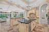 An open concept layout with casual living just beyond the kitchen. 5 sets of wall to wall sliders along the back of the home offer amazing views to th
