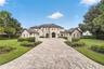 Exterior View. This home offers an extended paver drive with side parking pads and twin motor courts for garage parking for 4 vehicles + left side ent