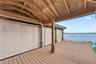 The 30'x12' Boat House can hold up to a 29' boat and has an NEW electric LIFT for up to 5500 lbs. and NEW remote cover. Underneath a Regal LS4 Fully L