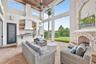 This area of the covered lanai is screened with a remote controlled screen to the covered outdoor dining area and pool. Full summer kitchen with bar. 