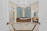This primary bath was remodeled in 2020 and features soaking jetted spa tub, his & her granite topped vanities, make-up area, STEAM multi-head shower 