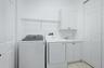 laundry room with cabinets and storage closet