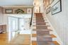 Entry Foyer in the foreground and stairs to the 2nd floor .