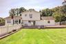 View of the rear of the home. Another manicured lawn.