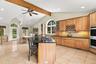 Expansive granite surfaces, custom cabinetry and a substantial center island create a kitchen of exceptional scale.