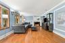 Architectural columns, rich hardwood floors and a handsome fireplace create timeless appeal.
