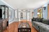 An impressive living room anchored by a handsome fireplace and abundant natural light.