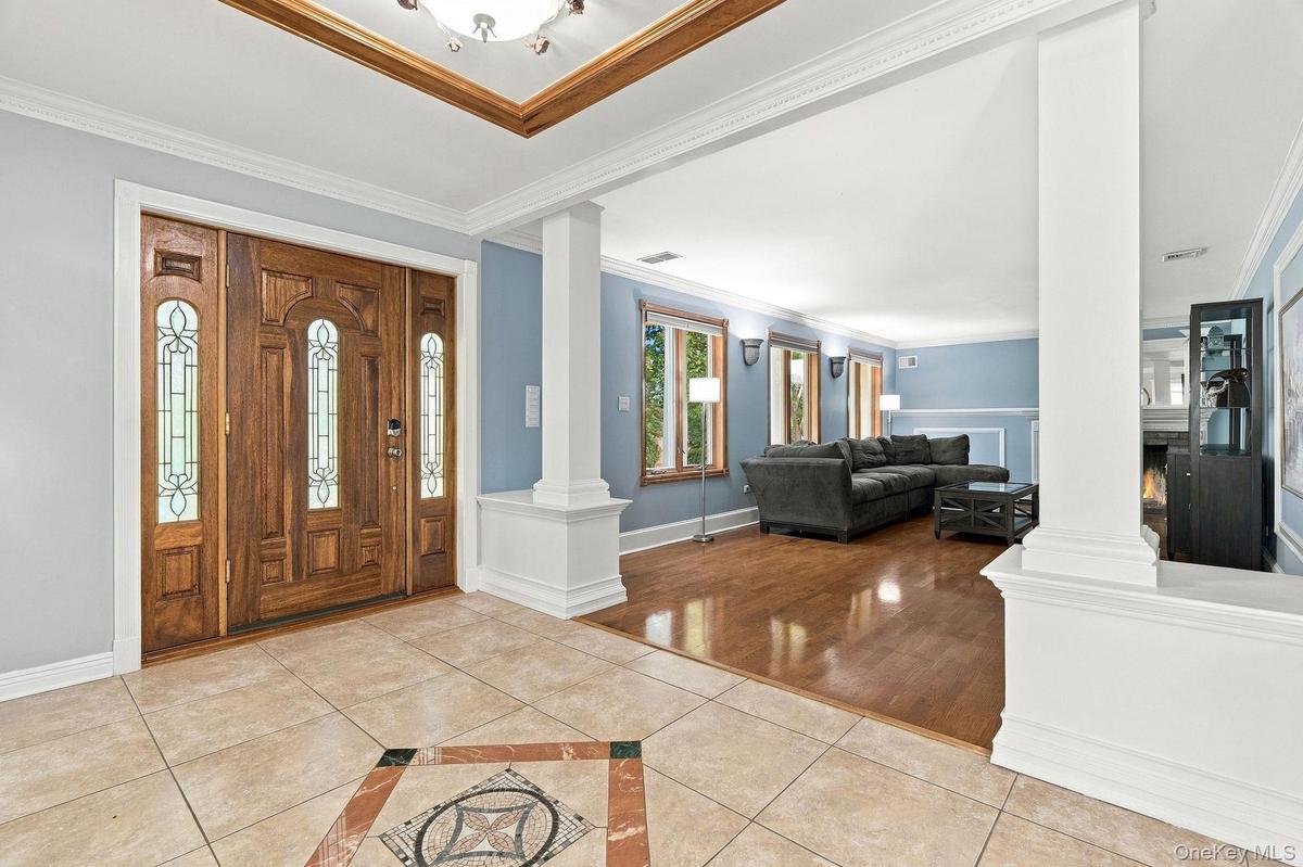A custom-tiled foyer sets the tone with rich materials and refined architectural detail.