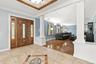 A custom-tiled foyer sets the tone with rich materials and refined architectural detail.