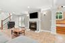 A welcoming family room centered around a handsome gas fireplace.