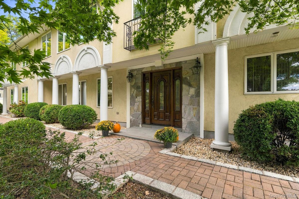 A striking stucco residence defined by graceful arches, elegant columns and unmistakable presence.
