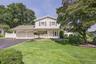 Manicured lawn, spacious driveway and 2 car garage.
