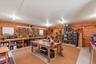 Virtually Staged. Workroom showcasing the extensive shelving, workbenches, and flexible space for projects, hobbies, or storage.