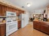 Bright kitchen featuring generous cabinet storage, a breakfast counter, and easy flow to the dining room.