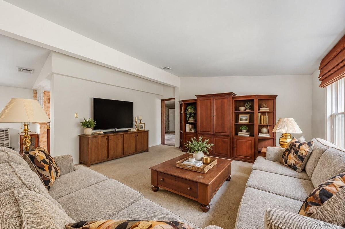 Large living room with ample wall space for entertainment and plenty of room for multiple seating areas.