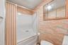 Full bathroom featuring a tub/shower combination, mirrored medicine cabinet, and practical layout.