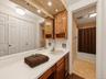 Primary bathroom highlighting the spacious vanity, storage, and tub/shower area.