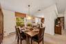 Virtually Staged. Bright dining area with a large window, comfortable seating space, and direct access to the nearby kitchen.