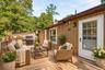 Virtually staged deck showcasing a comfortable outdoor seating area and grilling space.