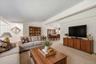 Spacious living room with generous seating space and an open connection to the adjacent dining area.