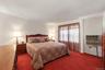 Well-sized bedroom with natural light and a flexible layout that accommodates a full bedroom suite.