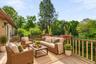 Virtually staged deck highlighting the peaceful backyard views and generous outdoor living space.