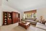 Bright living room with a large window overlooking the surrounding greenery and providing abundant natural light.