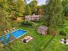 Virtually enhanced aerial view highlighting the pool, entertaining areas, fire pit, and generous backyard setting.