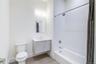 Full bathroom featuring toilet, shower / tub combo, and vanity