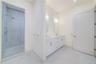 Bathroom with a shower with shower door and vanity
