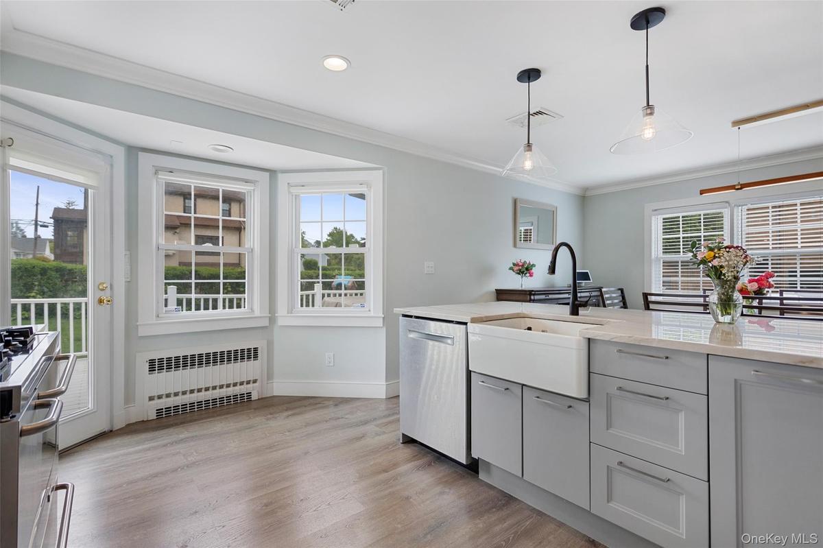 Bright kitchen with bay window and farmhouse sink.
