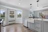 Bright kitchen with bay window and farmhouse sink.
