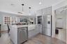 Contemporary kitchen with island and farmhouse sink.