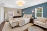 Spacious primary bedroom with hardwood flooring.